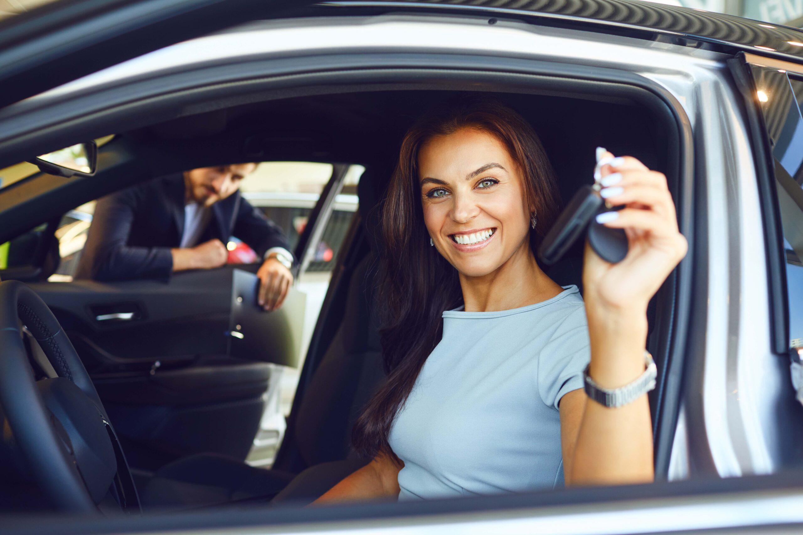 A Male Buyer Is Sitting In A New Car.